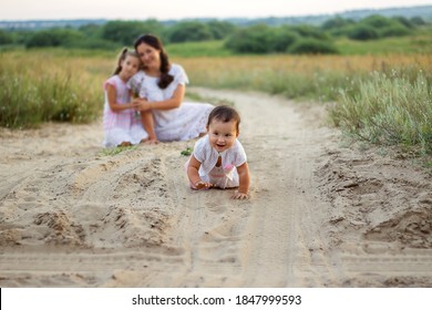 Naughty Baby Crawls Away From Mom And Sister In Nature