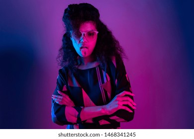 Naughty Fashion Young African American Girl Black Woman Wear Stylish Pink Glasses Arms Crossed Show Tongue Look At Camera Isolated On Party Purple Studio Background, Portrait, Copy Space