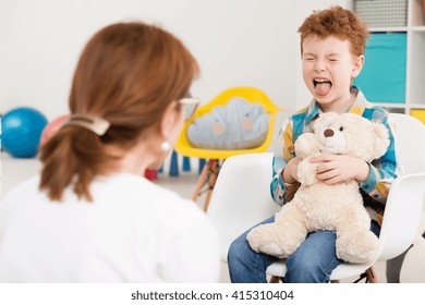 Naughty Young Boy With Adhd Screaming At Psychologist's Office