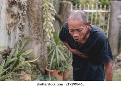 A Nauseated And Gaunt Old Man Hunches Down To Vomit. The Sensation Of Vomiting Or Gag Reflex.