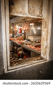 Nauseating view through an open window into an African, unhygienic chicken slaughterhouse at the public meat market in Port Louis, Mauritius