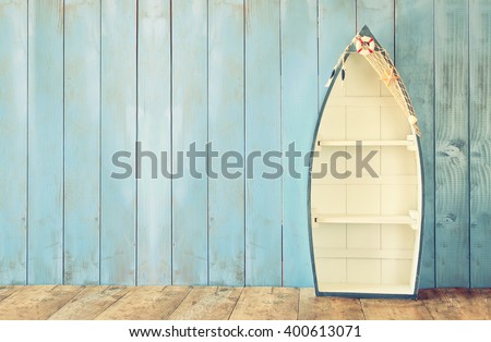 nautical boat shape shelves on wooden table. product display background, vintage filtered