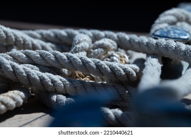 Nautical Consumed Thick Rope Coil On Wooden Boat Deck 