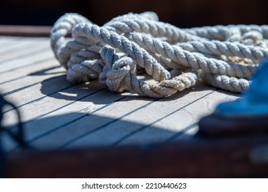 Nautical Consumed Thick Rope Coil On Wooden Boat Deck 