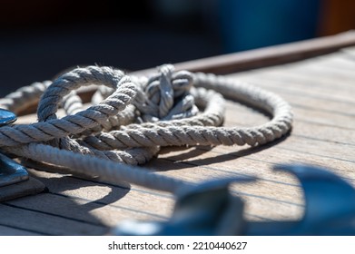 Nautical Consumed Thick Rope Coil On Wooden Boat Deck 