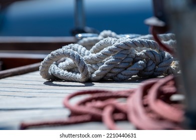 Nautical Consumed Thick Rope Coil On Wooden Boat Deck 