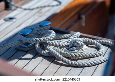 Nautical Consumed Thick Rope Coil On Wooden Boat Deck 