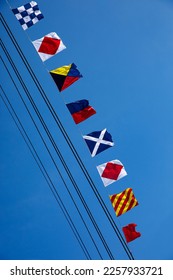 Nautical flags against blue sky - Shutterstock ID 2257933721