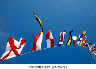 Nautical flags against blue sky - Shutterstock ID 2257933751