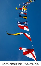 Nautical flags against blue sky - Shutterstock ID 2257933755