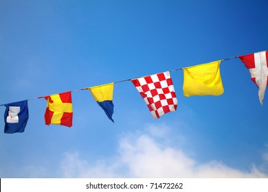 Nautical Flags Against Blue Sky