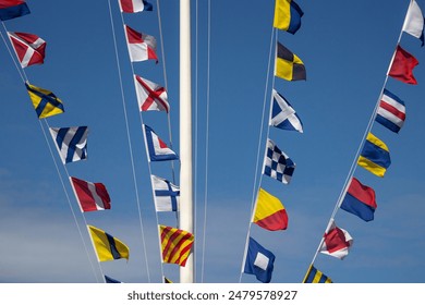 Nautical flags fluttering in the wind. Colorful signal flags	