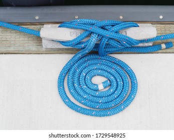 Nautical Rope Coiled On Dock In Marina 