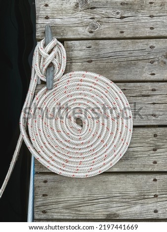 Nautical Style Rope Wound Up into a Spiral Circle on a Boat Dock.