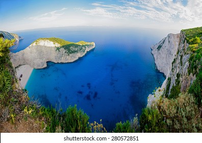 Navagio bay ( Shipwreck bay ) wide angle view from above. Famous paradise beach Navajo on Zakynthos island, Greece. Dawn, cliffs and sea greek landscape.