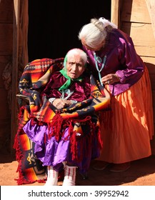 Navajo Family Of 2 Women Outdoors In Front Of Family Hogan