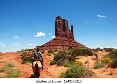 Navajo Guide In Lumberjack Shirt Leading A Horseback Tour Next To West Mitten Butte In Monument Valley - Arizona