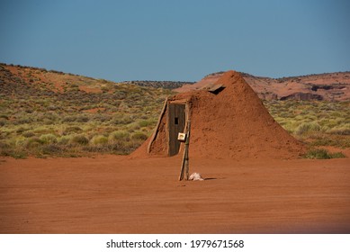 Navajo man-made clay hut with clear blue sky