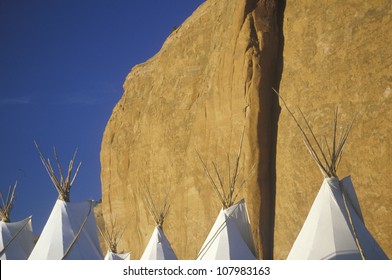 Navajo teepees against cliff, Gallup, NM