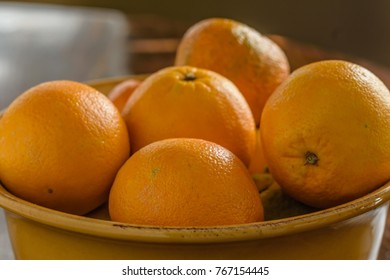 Navel Oranges In Bowl On Wood Table