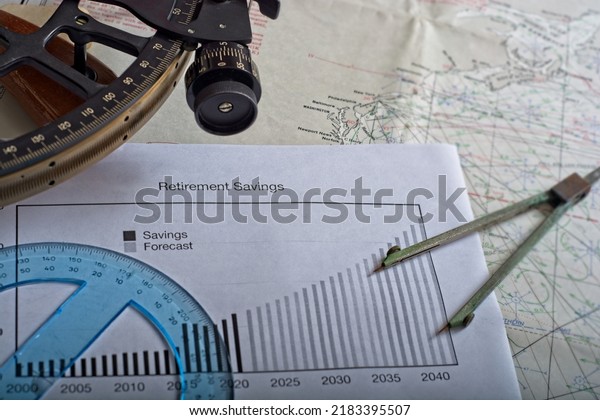 Navigating retirement concept with\
nautical theme of sextant protractor and dividers arranged around\
compound interest chart of savings set on navigation\
chart
