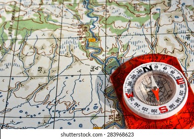 Navigation equipment for orienteering. Magnetic compass and topographic map. - Shutterstock ID 283968623