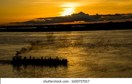 navigation on the Congo river 
transport on the Congo river economic activity on the Congo river sunset woman on dugout canoe women courage