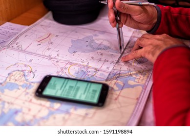 Navigation With Sea Charts In The Chart Room On A Sailing Yacht