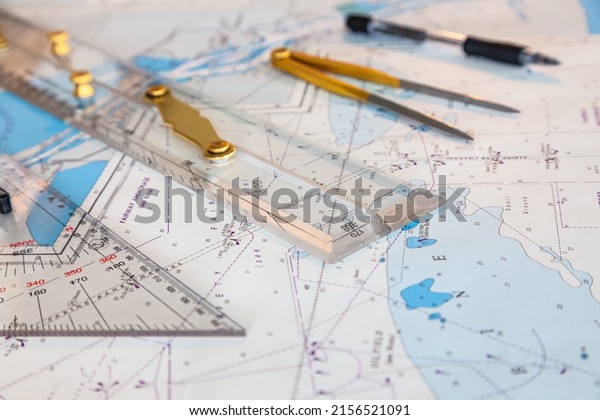 Navigation ship chart for building a\
sailing route. Plotter, divider, ruler and pen on a\
map.