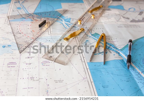 Navigation ship chart for building a\
sailing route. Plotter, divider, ruler and pen on a\
map.