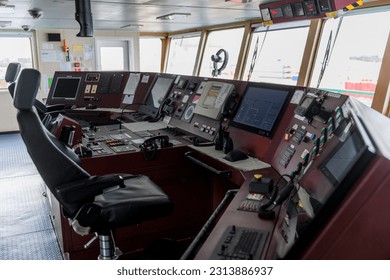 Navigational bridge on big cargo ship. Wheelhouse on vessel. ECDIS, radar. - Powered by Shutterstock