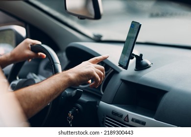 Navigator map in car vehicle transportation commuter. Driver man pointing hand finger mobile phone navigator app while driving car