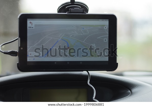Navigator on the windshield of\
the car. GPS navigation device in the car. Background with copy\
space