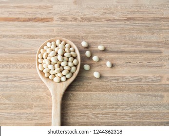 Navy Bean Or White Bean In Wooden Spoon Over Wood Background.