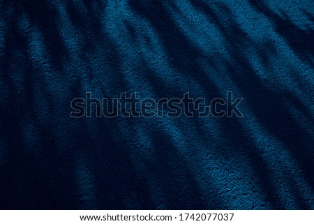  Navy blue abstract background with spots. Tree shadow pattern on asphalt at night. Toned dark blue grunge background. Shadow on the sidewalk. Light and shadow on a concrete stone surface.            