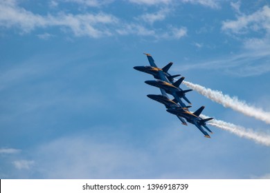 Navy Blue Angels formation with smoke