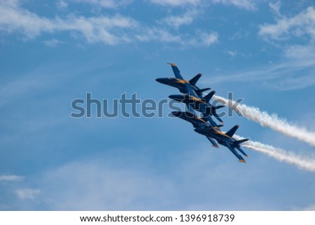 Navy Blue Angels formation with smoke
