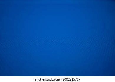 Navy, Blue Football Jersey Clothing Fabric Texture Sports Wear Background, Close Up. Sport Clothing Fabric Texture Background. Top View Of Cloth Textile Surface. Navy, Blue Football Shirt. 