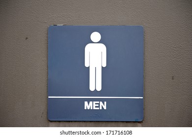 A Navy Blue, Men's, Bathroom Sign On A Brown Door.