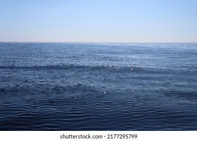 Navy Blue Sea Surface And Blue Sky In Horizontal