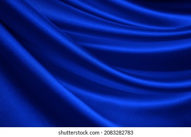   Navy blue silk satin  Wavy soft folds  Shiny fabric surface  Luxury background and copy space for design  Web banner  Birthday  Christmas  Valentine  holiday concept                                