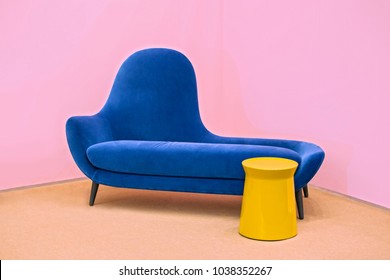 Navy Blue Sofa On A Pink Background, Laconic Interior.