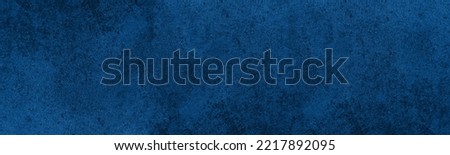 Navy blue textured surface. Indigo color rough panoramic texture. Dark dramatic abstract background