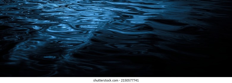      Navy blue water surface. Reflection of light. Ripples and waves. Night. Beautiful dark water background with copy space for design. Web banner. Panoramic. Close-up.                               