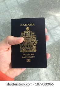 Navy Canada Passport In Man's Hand