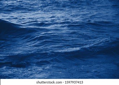 Navy Classic Blue Sea Water Texture. Classic Blue Pool Water With Sun Reflections. Trendy Colour 2020 Year. Classic Blue Background. Dark Classic Blue Sea Wave. Abstract Monochrome Texture. Color 2020