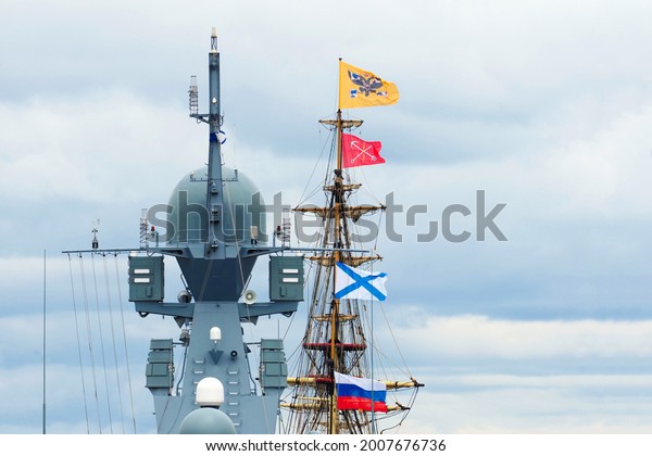Navy day of Russia. Sailboat and\
warship at holiday of the Russian Navy. Mixing old and\
modern