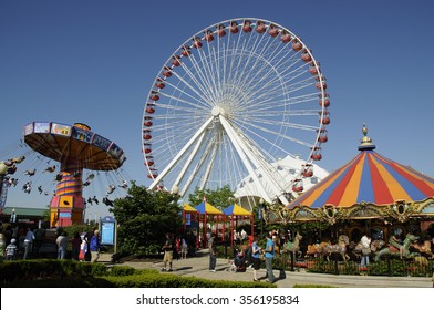 NAVY PIER AMUSEMENTS CHICAGO USA - CIRCA  2012 - Funfair Rides On The Ferris Wheel And Wave Swinger On Navy Pier Chicago Illinois USA