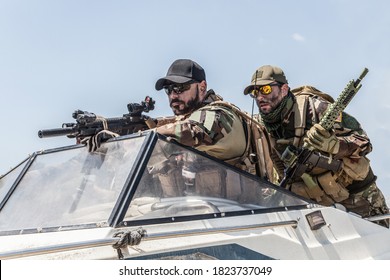 Navy SEALs Team Fighters, Army Special Operations Soldiers Squad, In Combat Uniform, Armed Submachine Gun And Service Rifle, Going Fast On Speed Boat, Chasing And Attacking Enemy, Patrolling Seacoast