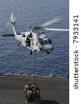 A Navy SH-60 Helicopter Performs Replenishment At Sea On the Nuclear Aircraft Carrier, USS Enterprise